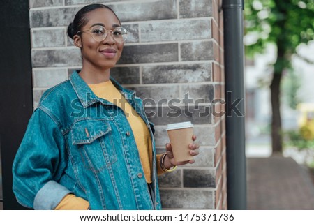 Happy young african american woman smilling and spending day in city