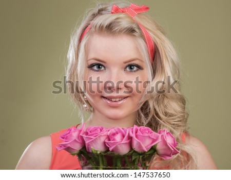 	The beautiful girl with a bouquet  flowers