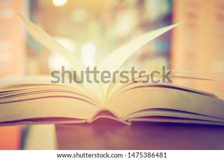 Academic Book on study desk in a library, education or concept picture of learning materials. School, college, or university conceptual image. Test or exam preparation prior to the evaluation day. 