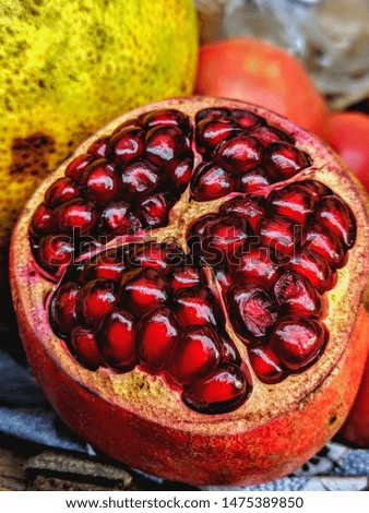 This is a close up pic of a freshly cut pomegranate. 