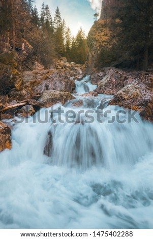 Flowing white water river through rocky cascades