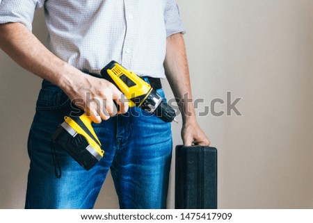 man with a suitcase of tools and a screwdriver