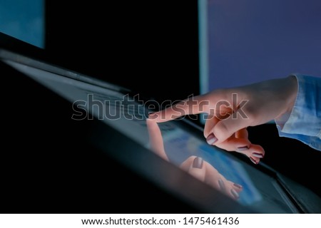 Woman using interactive touchscreen display of electronic multimedia kiosk at modern history museum. Education, learning and technology concept Royalty-Free Stock Photo #1475461436