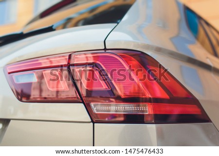 Closeup of car tail light on a white car..
