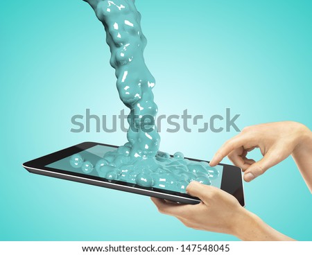 hands holding a tablet with green splash