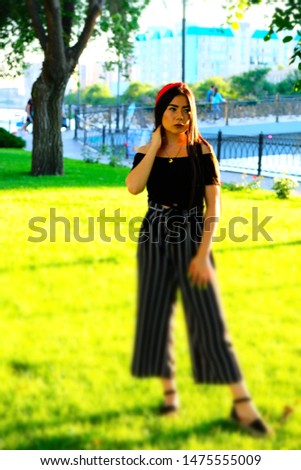 Full body shot of asian woman posing standing on grass in miniature style picture