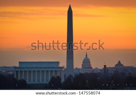 Washington DC city view at a orange sunrise, including Lincoln Memorial, Monument and Capitol building 