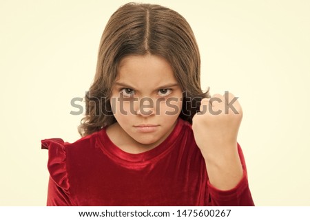 Threatening with physical attack. Kids aggression concept. Aggressive girl threatening to beat you. Dangerous girl. You are warned. Girl kid threatening with fist isolated on white. Strong temper. Royalty-Free Stock Photo #1475600267
