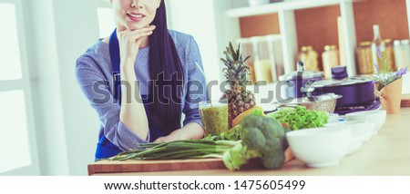 Young with with basket of fresh vegetables in the kitchen