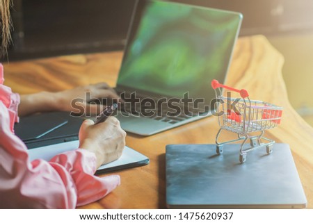 blurred photo,Young women are calculating the costs incurred by online shopping via credit cards.
Convenience concept with online shopping through Application and payment of products via credit card