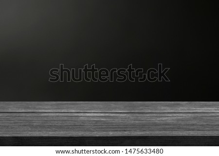 Real dark wood plank desk table top on black background, Can be used for display or montage your products. Royalty-Free Stock Photo #1475633480