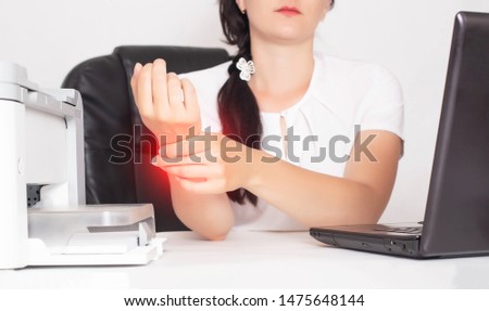 Young caucasian girl office worker holds on wrist joint pain and inflammation concept in hand, tunnel syndrome, businesswoman