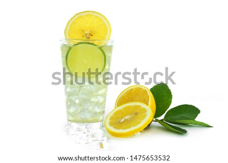 Lemonade with ice cubes and sliced lemon on white background.