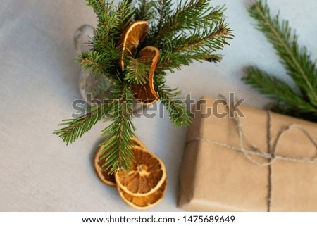 Christmas composition with fir branches, dried oranges and a gift box. Top view