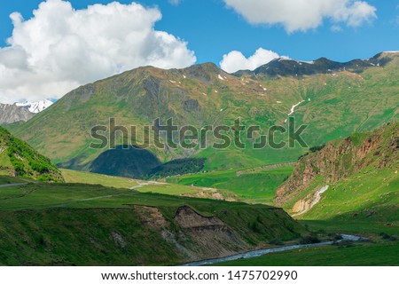 High beautiful Caucasus Mountains on the territory of Georgia, river and meadows