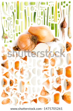 Large collection of yellow onion vegetable pieces, slices and leaves isolated on white background. Top view. Seamless abstract pattern.