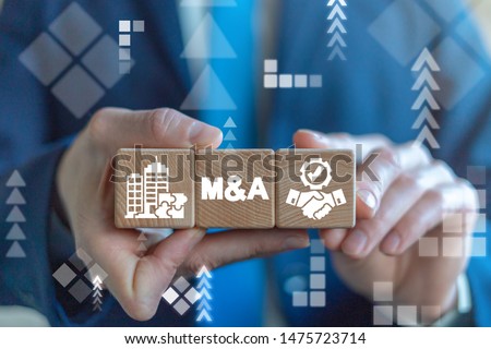 Merger and Acquisition Business Corporate Cooperation Company concept. MA partnership concept on wooden dices in businessman's hands. Royalty-Free Stock Photo #1475723714