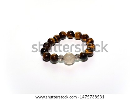 Tiger's eye stone and Rutile Quartz bracelet on whtie background.