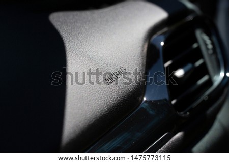 Airbag text on a modern car dashboard. Critical safety equipment.