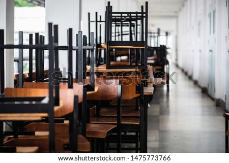 Many chairs overlap each other outside the classroom.