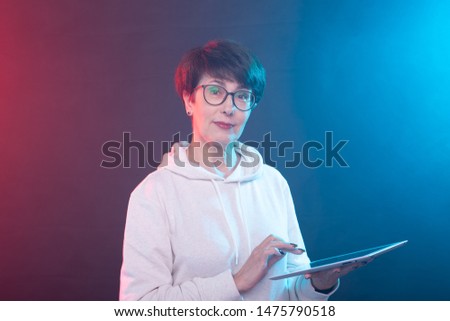 Technologies, internet and business concept - Smiling middle-aged woman with tablet computer