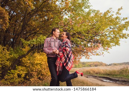 Loving couple on a date at a picnic in the autumn park at sunset