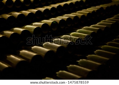 Rows of wine bottles stacked.