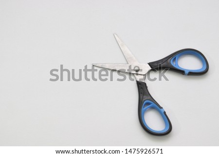 Scissors on White Background. With Black and Blue Handle. High Quality Photo. Useful for Many Purposes.