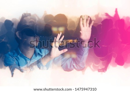 young asian officer man playing and hand touch effect of magic from Virtual reality with black hololens glasses