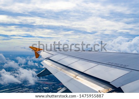 Take this picture from the plane from the sky with beautiful clouds.