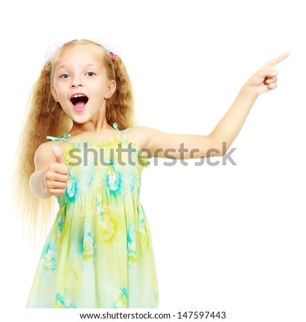Little girl in a green dress is pointing his finger