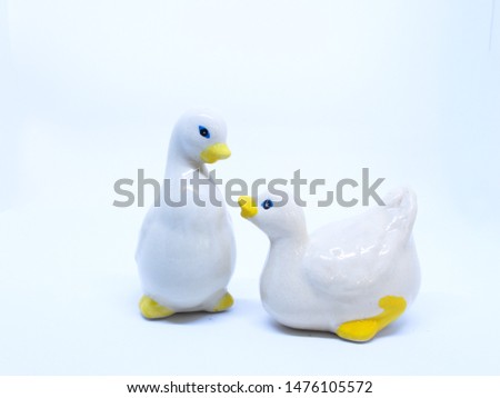 Ceramic ducks are on white background.