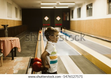 Cute child in bowling club