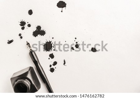 Calligraphy concept, pen for handwriting,spilled ink stains, brush,writing training,blank sheets of white paper ,Top view, place for text