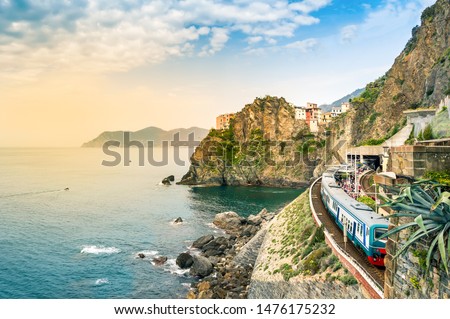 Manarola, Cinque Terre - train station in small village with colorful houses on cliff overlooking sea. Cinque Terre National Park with rugged coastline is famous tourist destination in Liguria, Italy Royalty-Free Stock Photo #1476175232