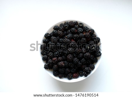 white bowl with blackberry on a white background