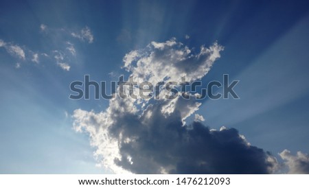 the light of sunshine behind clouds