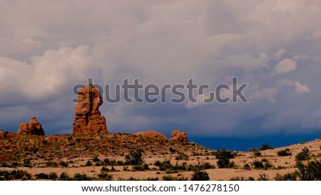 Storm clouds gathering over sandstone rock formations in Arches National Park, Utah