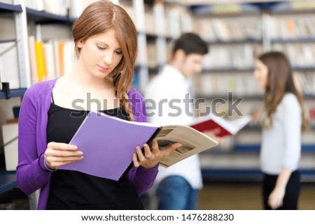 Woman holding a book in a library