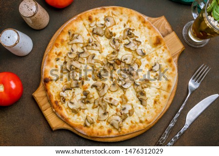 pizza with mushrooms on dark rustic background