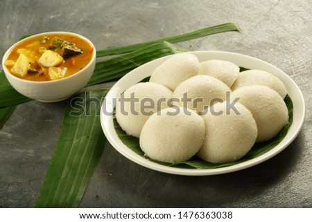 Homemade vegan foods- Indian breakfast idly or idlli served with tasty sambar dish 