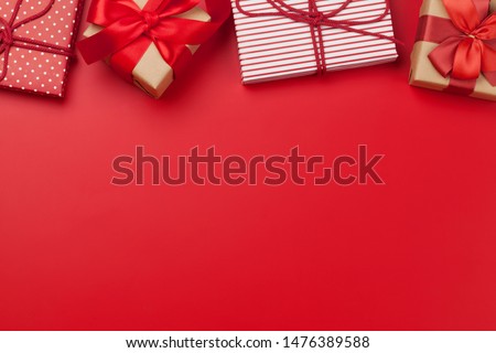 Christmas or Valentine's day gift boxes on red background. Top view with copy space. Flat lay Royalty-Free Stock Photo #1476389588
