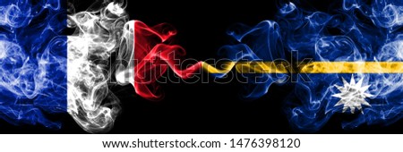 France vs Nauru smoky mystic flags placed side by side. Thick colored silky abstract smokes banner of French and Nauru