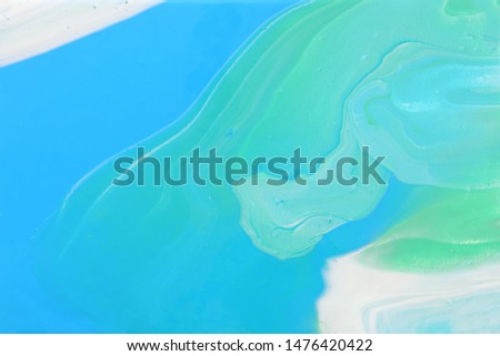 photography of abstract marbleized effect background. Blue, mint and white creative colors. Beautiful paint.