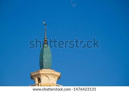 mosque minaret close up on blue sky background