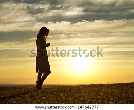 Portrait of a Woman walking thoughtfully at sunset Royalty-Free Stock Photo #147642977