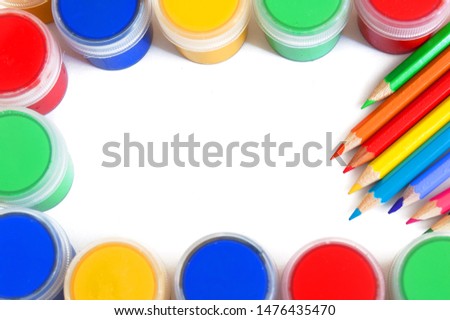 colorful paints, pencils and other stationery isolated on white background