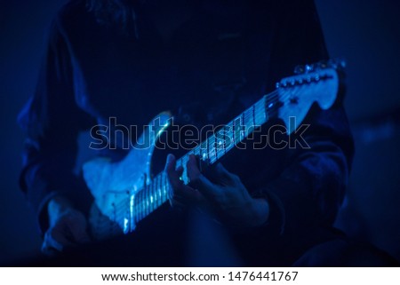Guitarist playing live music on the stage