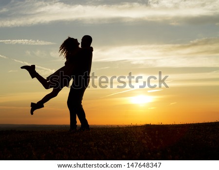 Happy Couple at Sunset Royalty-Free Stock Photo #147648347