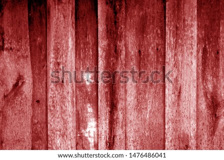 Weathered wooden fence in red color. Abstract background and texture for design.